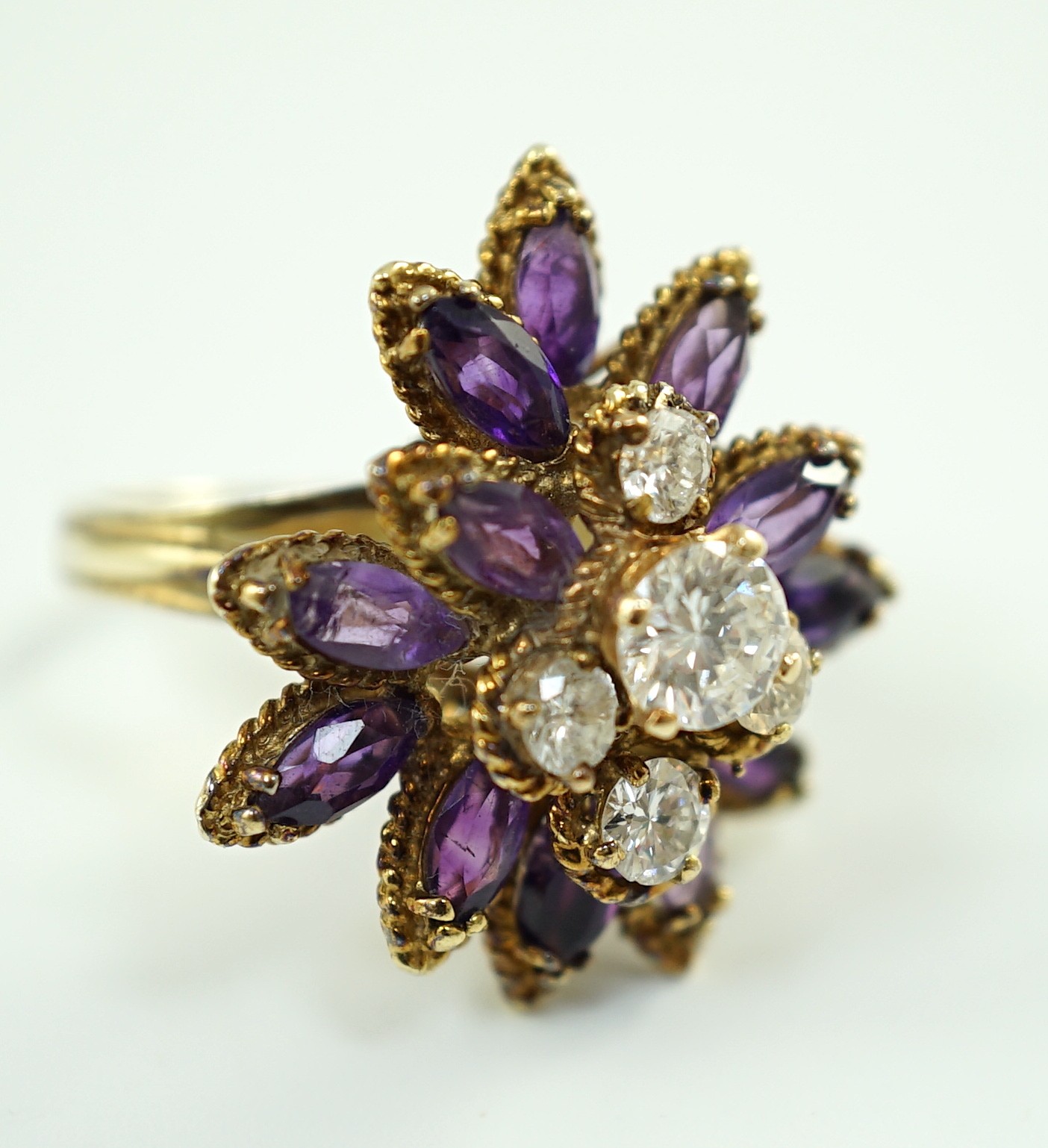 A 14k gold, five stone graduated round cut diamond and twelve stone marquise cut amethyst set cluster dress ring